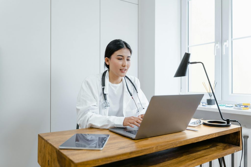 Doctor talking to patient on a laptop